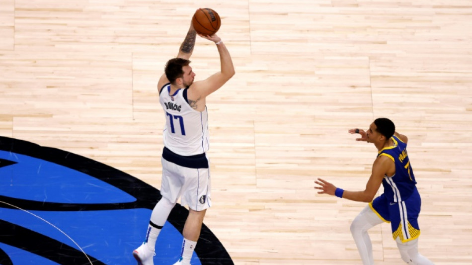 Doncic helps Mavs down Warriors to keep series alive